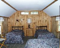 Bed room showing queen and twin beds of Pine Cottage